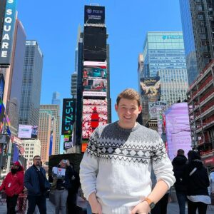 Robby Miller standing in the middle of Times Square